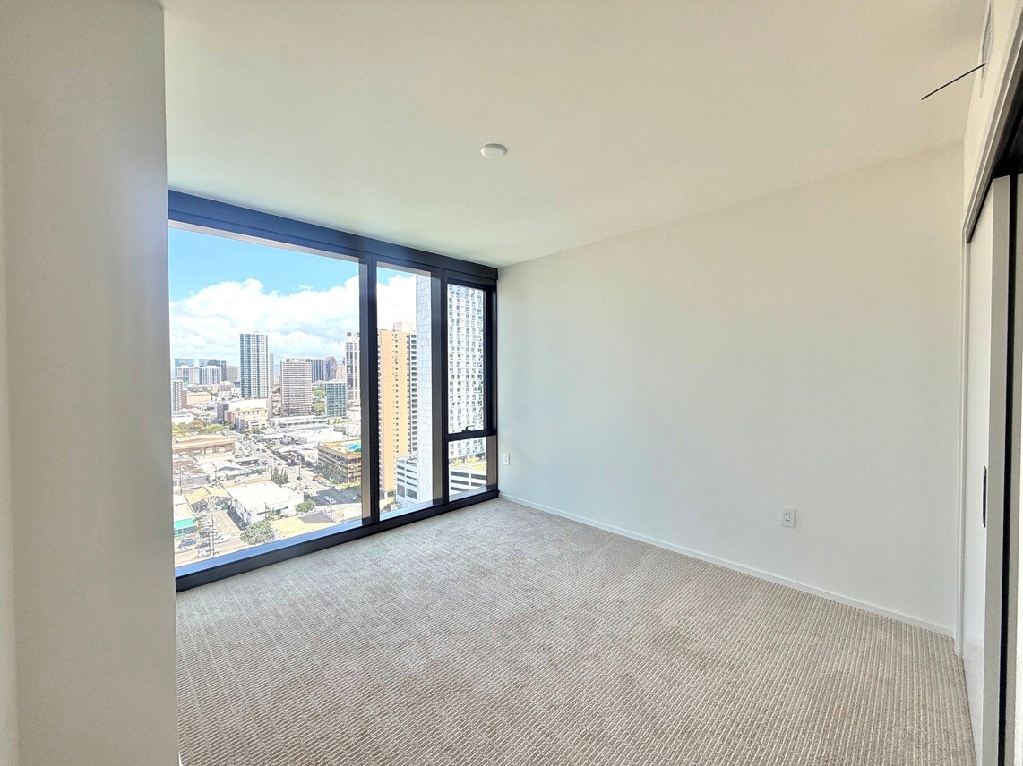 A room with a large window overlooking a cityscape.